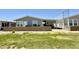 Single-story home with a covered patio and a low brick retaining wall in the yard at 650 N Hawes Rd # 2827, Mesa, AZ 85207