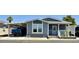 Charming home featuring a carport, desert landscaping, and a cozy front porch area at 650 N Hawes Rd # 2827, Mesa, AZ 85207