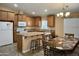 Well-appointed kitchen featuring granite countertops, island with seating, and modern appliances at 650 N Hawes Rd # 2827, Mesa, AZ 85207