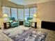 Comfortable living room featuring tile flooring, two plush chairs, and a wall of windows at 650 N Hawes Rd # 2827, Mesa, AZ 85207