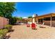 Spacious backyard with patio furniture, pool, rock features, and lush greenery creating an inviting outdoor oasis at 6533 E Kelton Ln, Scottsdale, AZ 85254