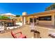 Charming backyard with patio furniture, lush landscaping, and a firepit, offering a serene and inviting outdoor space at 6533 E Kelton Ln, Scottsdale, AZ 85254