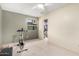 Bright bedroom with carpet and ceiling fan features exercise equipment and closet at 6533 E Kelton Ln, Scottsdale, AZ 85254