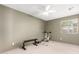 Spacious, carpeted bedroom with neutral colors, a ceiling fan, and exercise equipment at 6533 E Kelton Ln, Scottsdale, AZ 85254