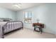 This bedroom features light blue walls, neutral carpet, ceiling fan, and a vintage Singer sewing table at 6533 E Kelton Ln, Scottsdale, AZ 85254