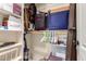 Walk-in closet is well-organized with a variety of clothes, luggage, and storage boxes at 6533 E Kelton Ln, Scottsdale, AZ 85254