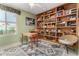 Cozy office with custom built-in shelving, desk, and patterned rug at 6533 E Kelton Ln, Scottsdale, AZ 85254