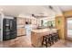 The kitchen has custom cabinets, black appliances, and a breakfast bar with stools at 6533 E Kelton Ln, Scottsdale, AZ 85254