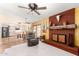 Open living space with tile and carpet flooring, fireplace, and an adjacent kitchen at 6533 E Kelton Ln, Scottsdale, AZ 85254