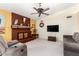 Comfortable living room showcasing custom fireplace, ceiling fan, and plush seating at 6533 E Kelton Ln, Scottsdale, AZ 85254