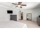 The main bedroom has neutral decor and features a dresser, a full length mirror and a TV at 6533 E Kelton Ln, Scottsdale, AZ 85254