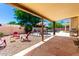 Covered patio featuring stone flooring, outdoor seating, and barbecue grill, perfect for relaxation and entertaining at 6533 E Kelton Ln, Scottsdale, AZ 85254