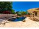 Inviting pool with rock features, surrounded by a stone patio, offering a serene and private backyard escape at 6533 E Kelton Ln, Scottsdale, AZ 85254