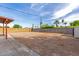 Expansive backyard with block fencing, mature trees, and a blank canvas for outdoor living at 655 E Hondo Ave, Apache Junction, AZ 85119