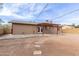 Backyard showcasing a covered patio, stone pavers, and generous space for outdoor enjoyment at 655 E Hondo Ave, Apache Junction, AZ 85119