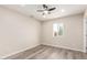 Bright, neutral bedroom with wood laminate flooring, natural light, and a ceiling fan for comfortable living at 655 E Hondo Ave, Apache Junction, AZ 85119