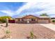 Charming single-story home featuring a well-maintained yard and an attached garage for convenient parking at 655 E Hondo Ave, Apache Junction, AZ 85119