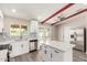 Bright modern kitchen with white cabinets, stainless steel appliances, an island, and an open layout at 655 E Hondo Ave, Apache Junction, AZ 85119