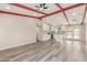 Bright open-concept living room and kitchen with exposed beam and wood laminate flooring at 655 E Hondo Ave, Apache Junction, AZ 85119