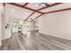 Bright open-concept living room and kitchen with exposed beam and wood laminate flooring at 655 E Hondo Ave, Apache Junction, AZ 85119