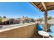 Relaxing balcony view with two blue chairs, a table, and a neighborhood view with palm trees at 6938 W Wescott Dr, Glendale, AZ 85308