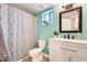 Bright bathroom featuring a vanity, mirror, and a decorative shower curtain at 6938 W Wescott Dr, Glendale, AZ 85308