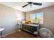 Comfortable bedroom with ceiling fan, window view, and cozy seating area at 6938 W Wescott Dr, Glendale, AZ 85308