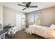 Cozy bedroom with a window view, desk, chair, and comfortable bed at 6938 W Wescott Dr, Glendale, AZ 85308
