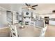 Open concept dining room with view to kitchen, fireplace, and stairway at 6938 W Wescott Dr, Glendale, AZ 85308