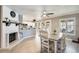 Open-concept dining area with fireplace, views of the kitchen and backyard access at 6938 W Wescott Dr, Glendale, AZ 85308