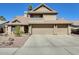 Inviting two-story home featuring a three-car garage and desert landscaping in a sunny locale at 6938 W Wescott Dr, Glendale, AZ 85308