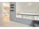 Open hallway with floating shelves and views to the staircase and sitting area at 6938 W Wescott Dr, Glendale, AZ 85308