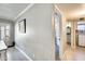 Hallway leading to a bathroom and dining room with natural light at 6938 W Wescott Dr, Glendale, AZ 85308