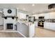 Modern kitchen with stainless steel appliances, an island, and a decorative brick fireplace at 6938 W Wescott Dr, Glendale, AZ 85308