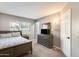 Cozy main bedroom featuring a window, closet, and a dresser with a mirror at 6938 W Wescott Dr, Glendale, AZ 85308