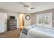 Bright main bedroom featuring a ceiling fan and access to a private balcony at 6938 W Wescott Dr, Glendale, AZ 85308