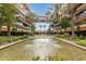 Beautiful courtyard featuring a pond with fountains and lush landscaping surrounded by multi-story buildings with balconies at 7117 E Rancho Vista Dr # 2003, Scottsdale, AZ 85251