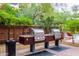 Outdoor grilling area featuring two stainless steel grills and a lush garden backdrop at 7117 E Rancho Vista Dr # 2003, Scottsdale, AZ 85251
