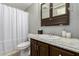 Neat bathroom with a shower, toilet, and sink at 7302 E Baseline Rd, Mesa, AZ 85209