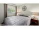 Cozy bedroom featuring soothing wall art and window with backyard views at 7302 E Baseline Rd, Mesa, AZ 85209