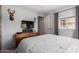 This bedroom offers a TV, closet and a window at 7302 E Baseline Rd, Mesa, AZ 85209