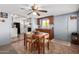 Cozy dining room with classic wood table, adjacent to the kitchen, ideal for Gathering meals at 7302 E Baseline Rd, Mesa, AZ 85209