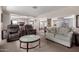 Bright and airy living room with open layout, plush seating, and easy access to the adjacent kitchen and dining areas at 7302 E Baseline Rd, Mesa, AZ 85209