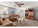Comfortable living room with a cozy seating arrangement, ample natural light, and a classic ceiling fan for year-round comfort at 7302 E Baseline Rd, Mesa, AZ 85209