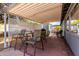 Open outdoor patio with brick pavers, dining table, chairs, and barbecue grill for entertaining at 7302 E Baseline Rd, Mesa, AZ 85209