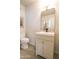 Neutral bathroom featuring a modern vanity, lighting, toilet, and large mirror at 7802 E Kimsey Ln, Scottsdale, AZ 85257