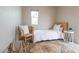 Bright bedroom features white walls and bedding, as well as a colorful rug at 7802 E Kimsey Ln, Scottsdale, AZ 85257