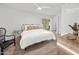 Cozy bedroom with a white bed, wood floors, a ceiling fan and bright walls at 7802 E Kimsey Ln, Scottsdale, AZ 85257