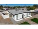 Beautifully updated home with a modern white exterior, desert landscaping and private, fenced-in front yard at 7802 E Kimsey Ln, Scottsdale, AZ 85257