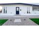 Updated home with xeriscaped front yard with grass, gravel, and modern exterior accents at 7802 E Kimsey Ln, Scottsdale, AZ 85257